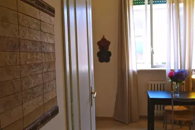 a room with a door and a table and a window at Suite China Soul - Flaminio - Olimpico - Auditorium in Rome