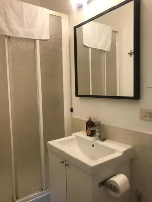 a bathroom with a white sink and a mirror at Suite China Soul - Flaminio - Olimpico - Auditorium in Rome