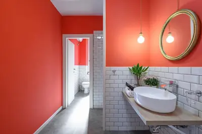 a bathroom with a white sink and red walls at GLAM 50 - Exlusive Penthouse in the Heart of Rome in Rome