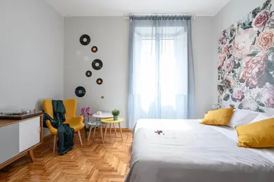 a bedroom with a bed and a table and chairs at GLAM 50 - Exlusive Penthouse in the Heart of Rome in Rome