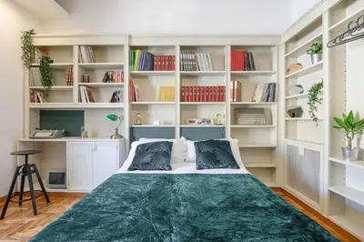 a bedroom with a large bed with white shelves at GLAM 50 - Exlusive Penthouse in the Heart of Rome in Rome
