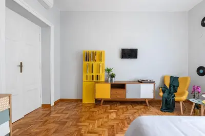 a bedroom with a desk and a yellow chair at GLAM 50 - Exlusive Penthouse in the Heart of Rome in Rome