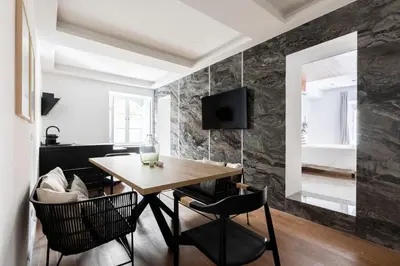 a dining room with a wooden table and chairs at Louly Trevi Fountain in Rome