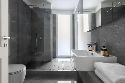 a bathroom with a white sink and a toilet at Louly Trevi Fountain in Rome