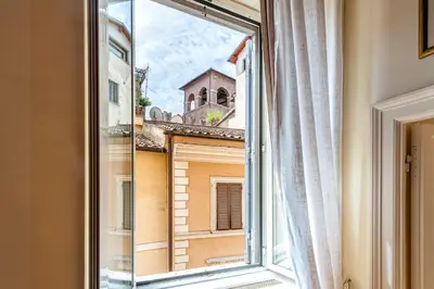 a kitchen with white cabinets and a sink at Piazza Navona Historic 2BR Loft Steps to Square IREX Apartment in Rome