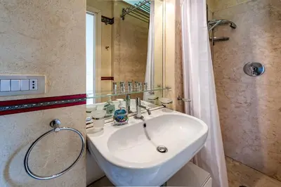 a small room with a bed with two towels on it at Piazza Navona Historic 2BR Loft Steps to Square IREX Apartment in Rome