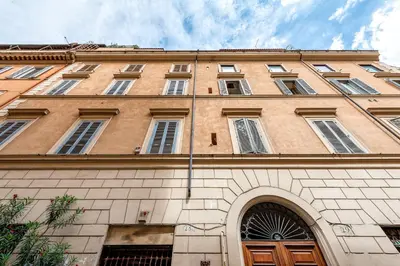a large wooden door on the side of a building at Piazza Navona Historic 2BR Loft Steps to Square IREX Apartment in Rome