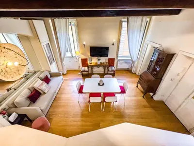 a bedroom with a bed with two towels on it at Piazza Navona Historic 2BR Loft Steps to Square IREX Apartment in Rome