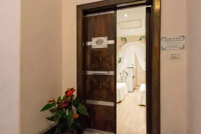 a wooden door with a mirror in a room at Etere in Prati Rooms in Rome