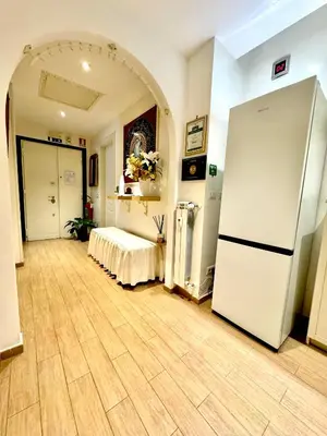 a large room with a white refrigerator in it at Etere in Prati Rooms in Rome