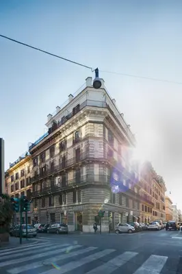 a large building on the corner of a street at NearHome Smart Suites Guest House in Rome