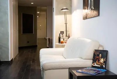 a living room with a white couch and a table at Borgo Pio Suites Inn in Rome