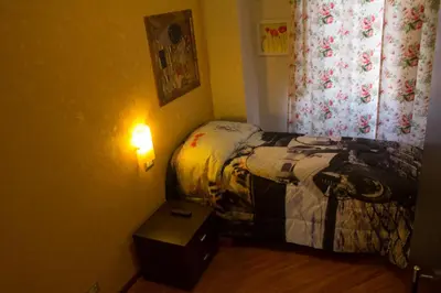 a small bedroom with a bed and a lamp at Affittacamere Mazzini in Rome