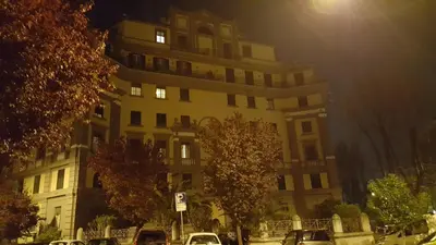 a large building with cars parked in front of it at Affittacamere Mazzini in Rome