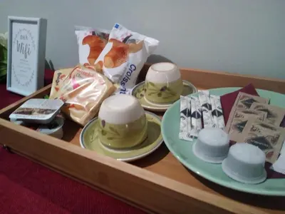 a wooden table with a tray with hats on it at Vatican Rooms Accommodation in Rome