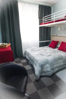 a bedroom with a bunk bed and a chair at Vatican Rooms Accommodation in Rome