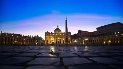 a large building with a mosque in front of it at night at Vatican Rooms Accommodation in Rome
