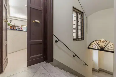 a hallway with a brown door and a window at Hotel Mimosa Pantheon in Rome