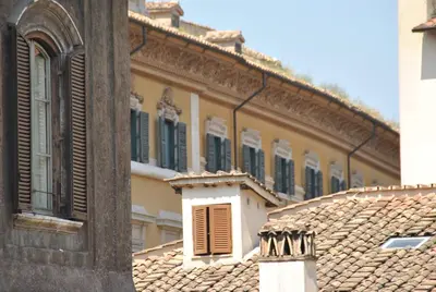 a building with green shuttered windows and roofs at Hotel Mimosa Pantheon in Rome