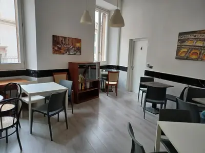 a dining room with tables and chairs in a room at Hotel Mimosa Pantheon in Rome