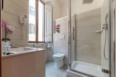 a bathroom with a toilet and a sink and a shower at Hotel Mimosa Pantheon in Rome