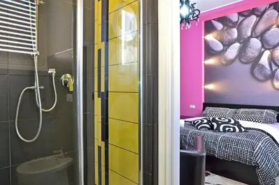 a bathroom with a shower and a bed in a room at G&G Trastevere in Rome