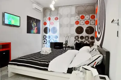 a bedroom with a black and white bed and a tv at G&G Trastevere in Rome