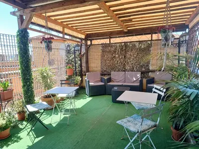a patio with tables and chairs and a couch at B&B Da Ponticello in Rome