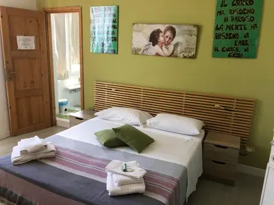 a bedroom with a large bed with towels on it at B&B Da Ponticello in Rome