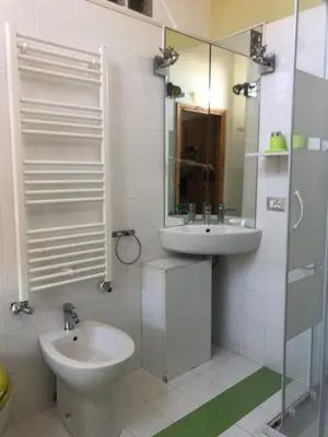 a bathroom with a sink and a toilet and a mirror at B&B Da Ponticello in Rome