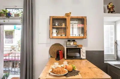 a kitchen with a table with a plate of food on it at iFlat Trastevere Bianca's House in Rome