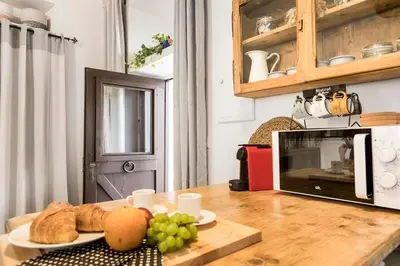 a table with a plate of bread and grapes on it at iFlat Trastevere Bianca's House in Rome