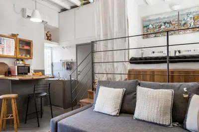 a living room with a couch and a kitchen at iFlat Trastevere Bianca's House in Rome