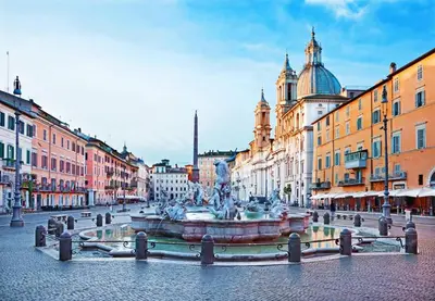 a fountain in the middle of a street with buildings at old corallo in Rome