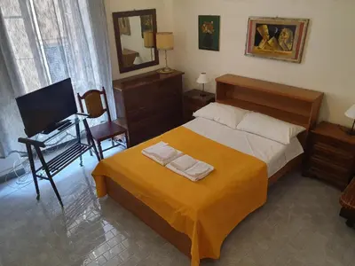 a bedroom with a bed and a desk and a television at old corallo in Rome