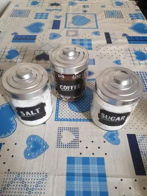 three containers of coffee sitting on a table at old corallo in Rome