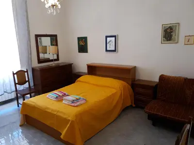 a bedroom with a yellow bed and a chair at old corallo in Rome