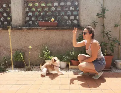 a woman is kneeling next to a dog at Relais Villa Fiorelli in Rome