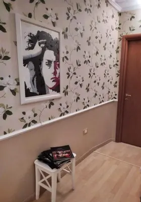a room with a painting on the wall and a table at Relais Villa Fiorelli in Rome