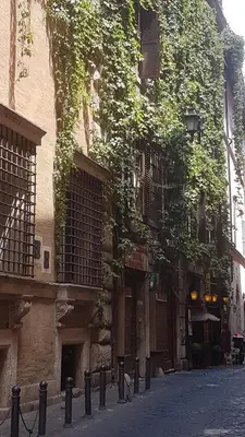 a bedroom with a bed and a nightstand with at Casa Vacanze Simona vicino a Piazza Navona in Rome