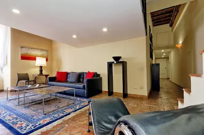 a living room with a couch and a table at Campo Dei Fiori Home in Rome