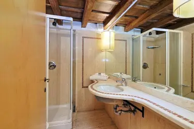 a bathroom with a sink and a shower at Campo Dei Fiori Home in Rome