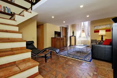 a living room with a couch and a table at Campo Dei Fiori Home in Rome