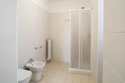 a bathroom with a shower and a toilet and a sink at Minerva Monks Inn in Rome