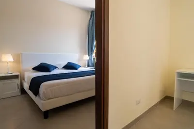 a bedroom with a bed with blue pillows at Minerva Monks Inn in Rome
