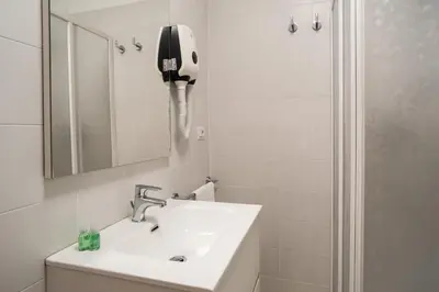 a bathroom with a sink and a mirror and a shower at Minerva Monks Inn in Rome