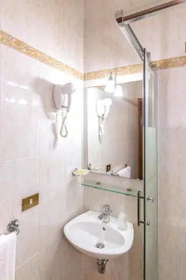 a bathroom with a sink and a shower at Downtown Accommodation in Rome