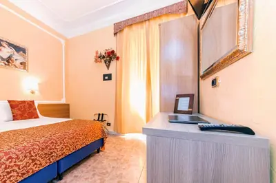 a hotel room with a bed and a desk at Downtown Accommodation in Rome