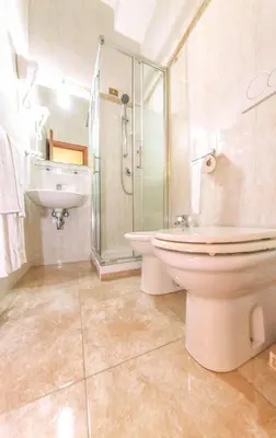 a bathroom with a toilet and a sink and a shower at Downtown Accommodation in Rome