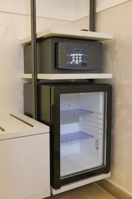 a refrigerator with a clock on top of it at B&B Smart Rooms in Rome